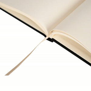 Close-up of the cream ribbon bookmark on a black canvas notebook | Pamusan.com