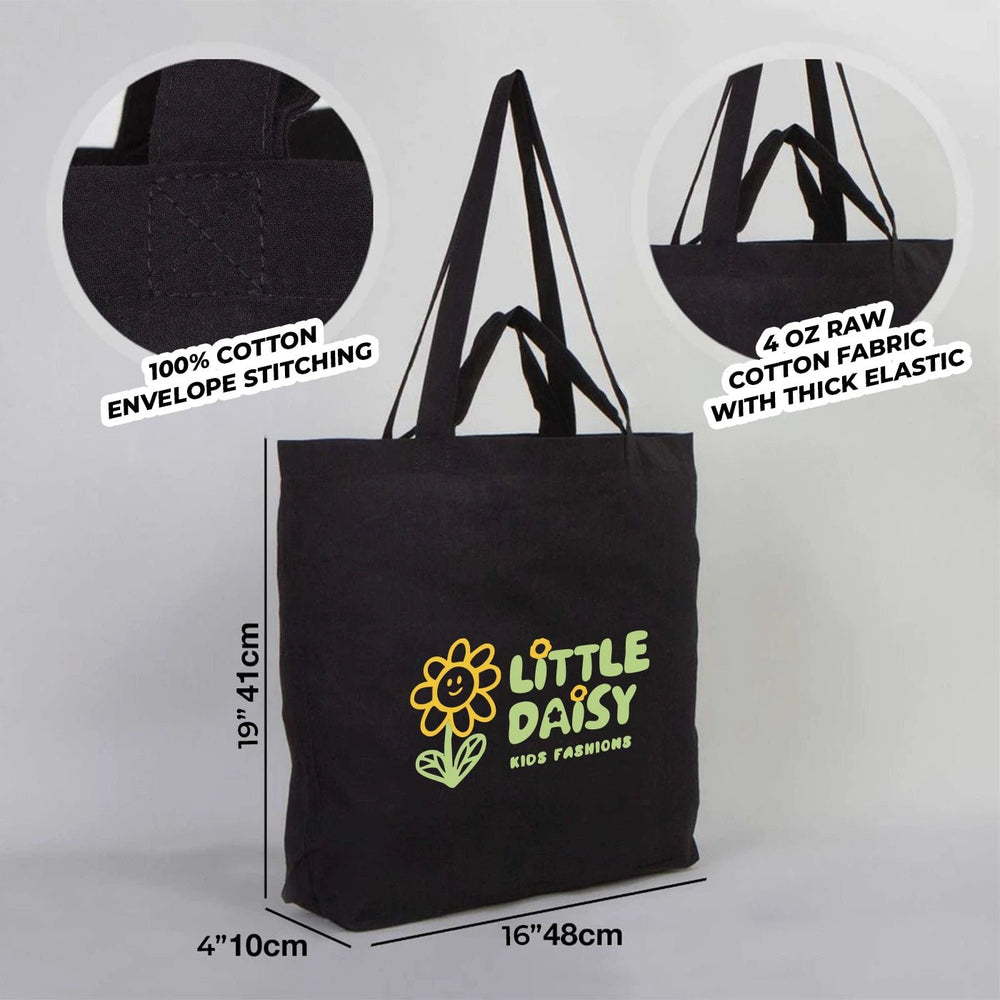 Black tote bag with customizable text on a wooden floor